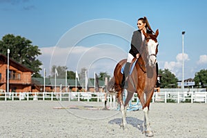 Rider elegant woman riding her horse outside