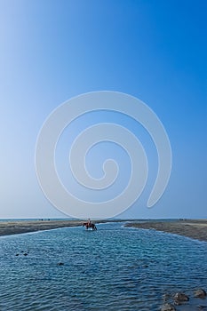 Rider galloping on horseback along the beach. Rides horse along the ocean. Pretty rider on the sea beach.