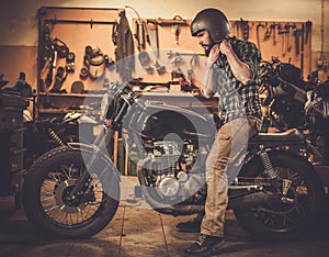 Rider and his vintage style cafe-racer motorcycle