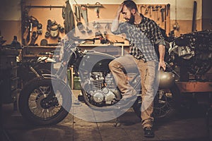 Rider and his vintage style cafe-racer motorcycle