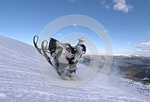 RIDER JUMP IN SNOWMOBILE IN THE SNOW IN WINTER