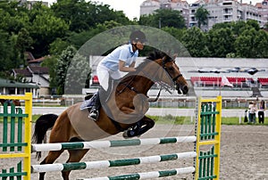 Rider jumping over the barrier-2