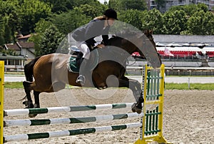 Rider jumping over the barrier-3