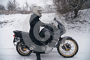 Rider man on adventure motorcycle. Winter fun. snowy day. the snow fall. off road dual sport crazy extreme ride, active life style