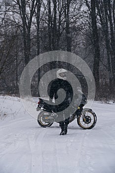 Rider man on adventure motorcycle. Winter fun. snowy day. the snow fall. off road dual sport crazy extreme ride, active life style