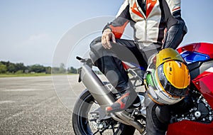 Rider motorbike holding his motorcycle helmet sitting on a big bike