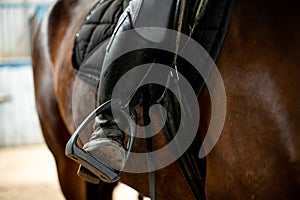 Rider`s foot in the stirrup