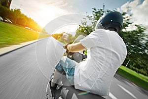 Rider on scooter motorcycle in parkway