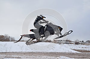 Rider on the snowmobile jumping