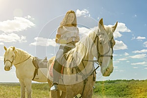 the rider on the white horse. Young horsewoman riding on white horse, outdoors view. girl on white horse runs free