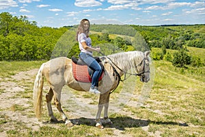 The rider on the white horse. Young horsewoman riding on white horse, outdoors view. girl on white horse runs free. toned