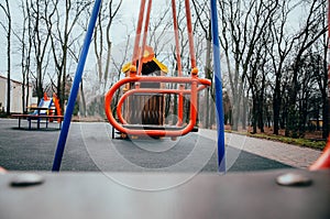 Rides on the playground. Centrifuge, swing for children. Wheel bottom view in  red