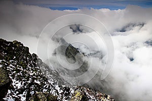 Ridge of Slavkovsky peak and Velka Studena valley in clouds photo