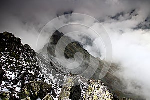 Ridge of Slavkovsky peak and Velka Studena valley in clouds photo