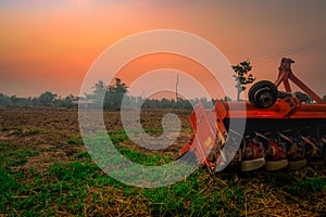 Ridging crackdown machine. Supply for tractor. Agricultural machinery in agriculture farm. Rice farm in morning with red sunrise