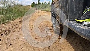 Riding a ATV in the mountains close-up of the wheel