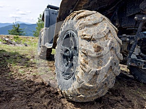 Riding a ATV in the mountains close-up of the wheel