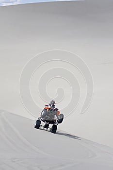 Riding ATV in sand dunes photo