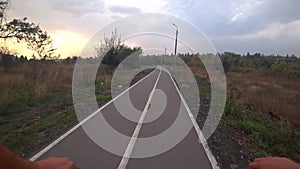 Riding a bicycle in city park. Pov rider.