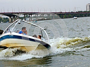 Riding a boat on the river, in the passable weather.