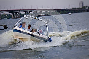 Riding a boat on the river, in the passable weather.