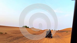 Riding buggies in the desert during sunset