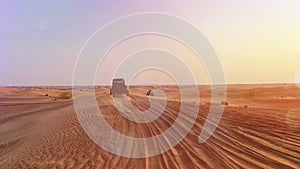 Riding buggies in the desert during sunset