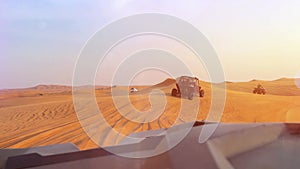 Riding buggies in the desert during sunset