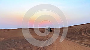 Riding buggies in the desert during sunset