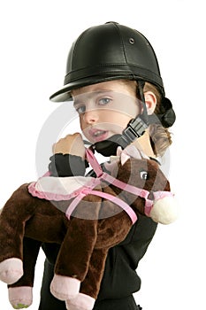 Riding cap little girl hug toy horse