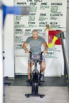 Riding exercise bike in gym