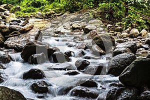 Riding the Flow: Slow Shutter Speed Images of Water Flowing Among the Rocks in Nature