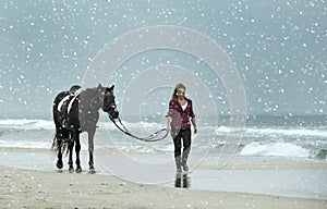 Riding girl and horse in winter