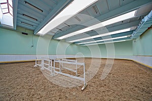 Riding hall with sandy covering