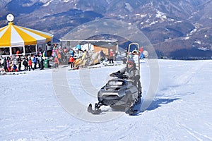 Riding High - Snowmobiler Takes to the Slopes on a Sun-Drenched Day in winter