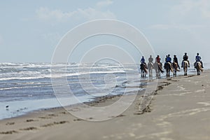 Riding horses on the beach in Texas