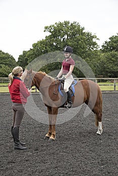 Riding lesson with the rider and instructor