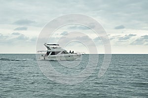 Riding a luxury white yacht in the open sea.