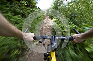 Riding mountain bike fast on a trail photo
