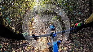 Riding a mountain bike rider handlebar point of view in the middle of a singletrack