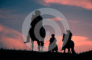 Riding nomadic horsemen on sunset