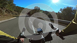 Riding a road bicycle on a black tarmac empty road in Girona