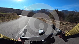 Riding a road bicycle on a black tarmac empty road in Girona