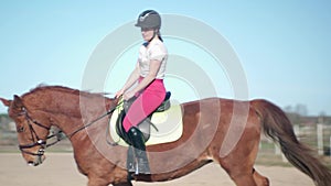 Riding school. Handsome young girl ride a horse slow motion 4K