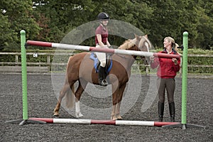 Riding school pupil and instructor