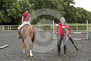 Riding school pupil and instructor