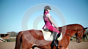 Riding school. Young handsome woman rides a horse slow mo 4K