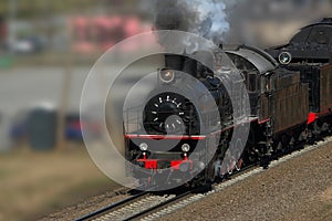 Riding steam train with puffs of smoke photo