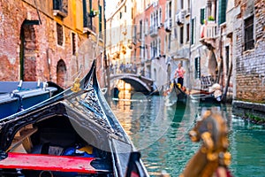 Riding a traditional gondola down the narrow canals in Venice, Italy.