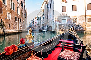 Riding a traditional gondola down the narrow canals in Venice, Italy.